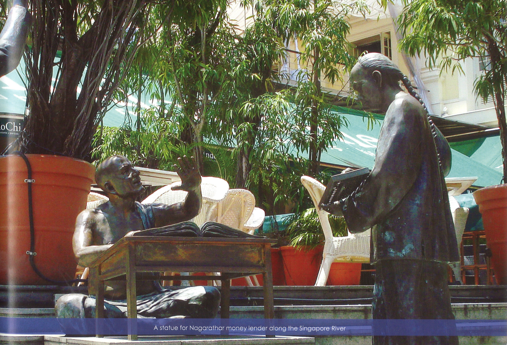 Detail of the Chettiar clerk and manager bronze statue sitting behind low desk